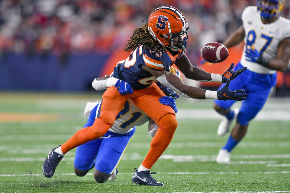 Syracuse wide receiver Courtney Jackson (85) makes a juggling catch while covered by Pittsburgh defensive back Erick Hallett II (31) during the first half of an NCAA college football game in Syracuse, N.Y., Saturday, Nov. 27, 2021. (AP Photo/Adrian Kraus)