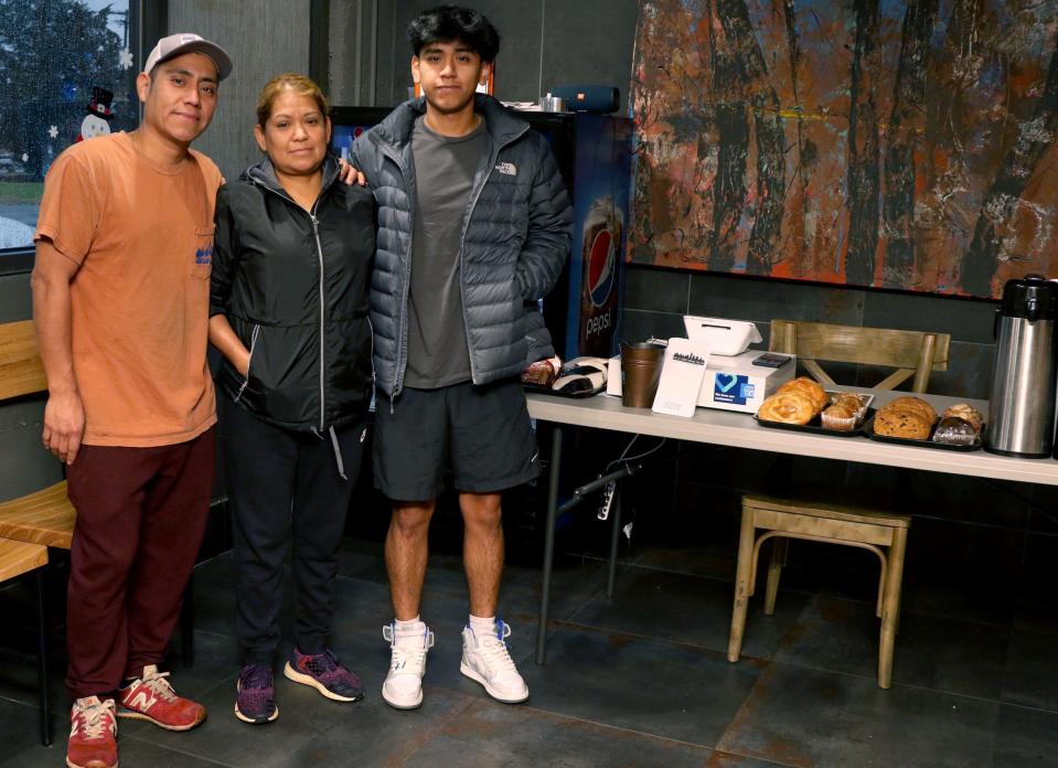 Owner Margarilo Coria poses with his wife Lucy Coria  and son Luis Coria early Thursday morning, Dec. 15, 2022, at De Coria's Bagels in Belmont.