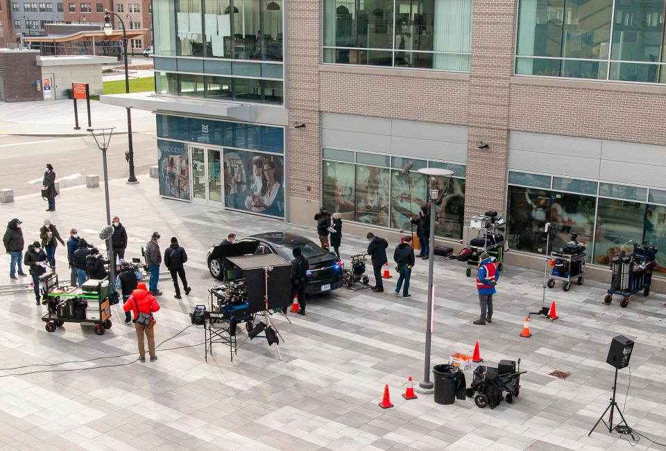 "Don't Look Up" movie production is centered around a car and characters wearing FBI jackets in the courtyard at Mercantile Center Friday.