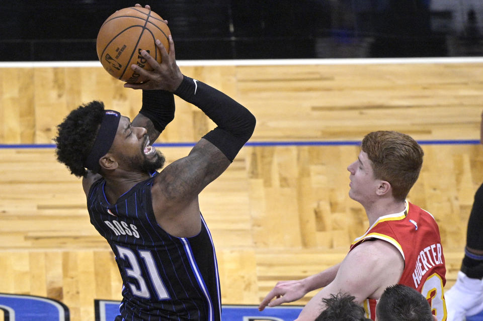 Orlando Magic guard Terrence Ross (31) shoots in front of Atlanta Hawks guard Kevin Huerter (3) during the second half of an NBA basketball game Wednesday, March 3, 2021, in Orlando, Fla. (AP Photo/Phelan M. Ebenhack)