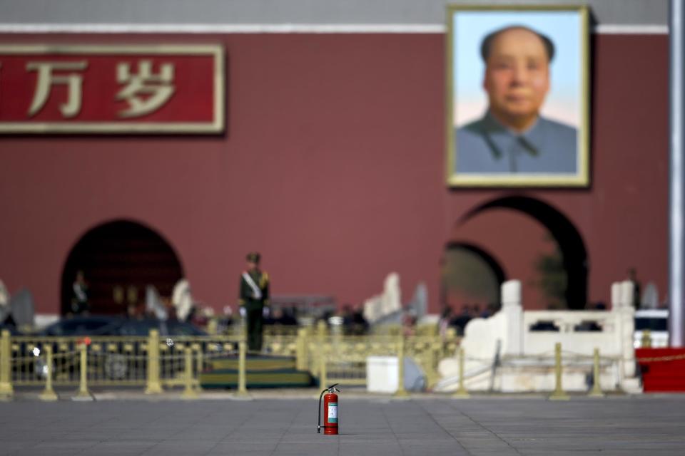 In this Wednesday, March 8, 2017 photo, a fire extinguisher sit in the middle of Tiananmen Square against a portrait of Mao Zedong during the National People's Congress held at the Great Hall of the People in Beijing. Because safety comes first, fire extinguishers are ubiquitous in and around Beijing’s Great Hall of the People during the annual sessions of China’s ceremonial parliament and its official advisory body. That’s partly for standard purposes of preventing any sort of fire-related emergency that could harm the participants and mar the proceedings. (AP Photo/Andy Wong)