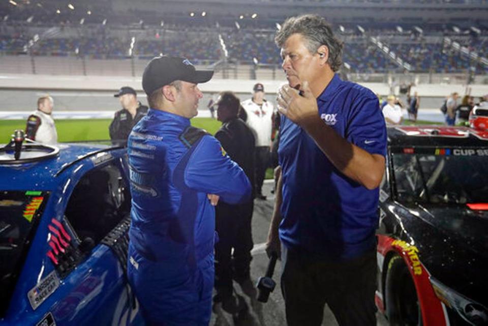 Reed Sorenson, left, talks with Michael Waltrip, a former driver and now TV commentator, on pit road before the first of two Daytona 500 qualifying auto races at Daytona International Speedway, Thursday, Feb. 13, 2020, in Daytona Beach, Fla.