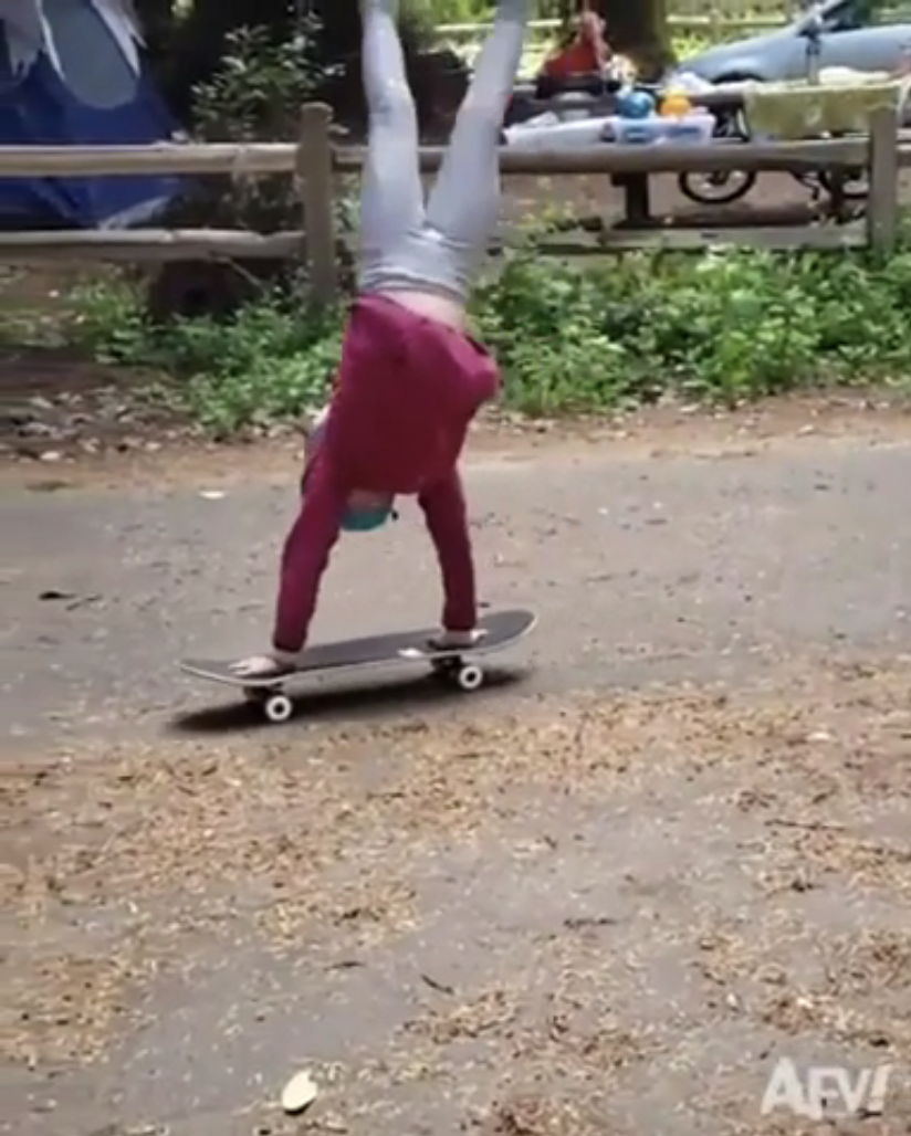 a person doing a hand stand on a skateboard