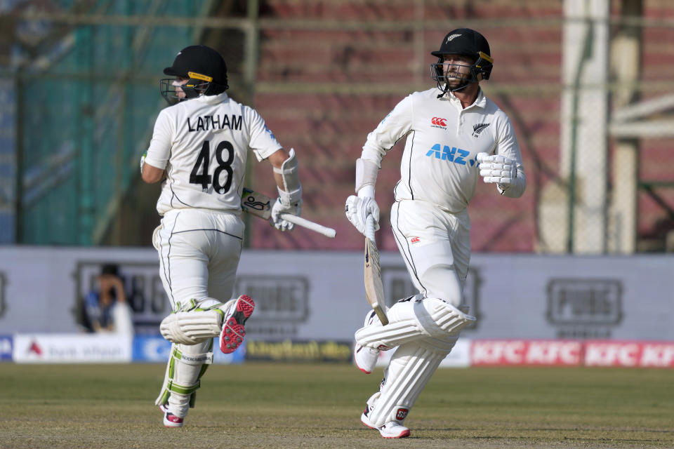 New Zealand's Devon Conway, right, and Tom Latham run between the wickets during the second day of first test cricket match between Pakistan and New Zealand, in Karachi, Pakistan, Tuesday, Dec. 27, 2022. (AP Photo/Fareed Khan)