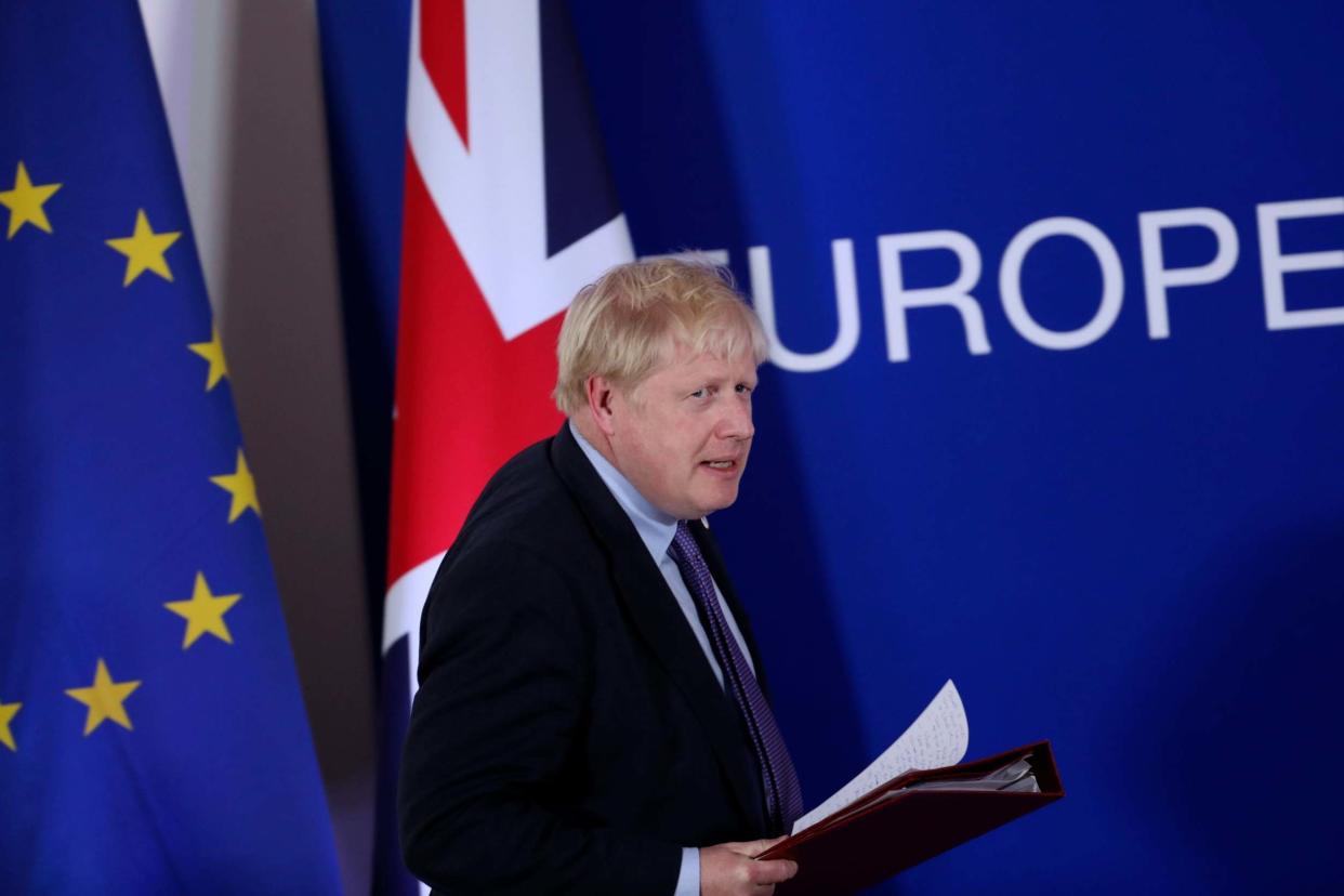 Boris Johnson prepares to address a media conference at an EU summit: AP