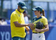 Australia's pitcher Kaia Parnaby is substituted by a coach during the softball game between Japan and Australia at the 2020 Summer Olympics, Wednesday, July 21, 2021, in Fukushima , Japan. (AP Photo/Jae C. Hong)