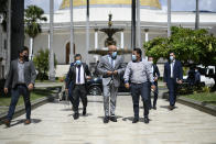 National Assembly President Jorge Rodriguez, center, arrives for an interview at Congress in Caracas, Venezuela, Friday, Jan. 15, 2021. Rodriguez said he’s hopeful the Biden administration will roll back a “cruel” sanctions policy and instead give room for diplomacy that could lead to the reopening of the U.S. Embassy and the release of several jailed American citizens. (AP Photo/Matias Delacroix)