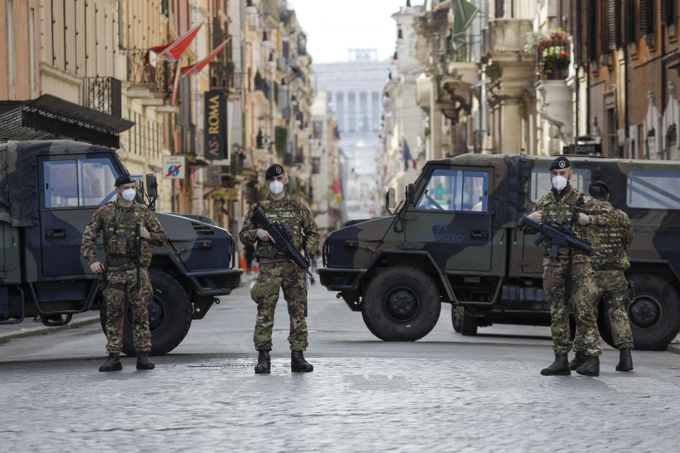 Italian Army officers patrol Rome's central Piazza del Popolo, Saturday, April 3, 2021. Italy went into lockdown on Easter weekend in its effort to battle then Covid-19 pandemic. (AP Photo/Gregorio Borgia)