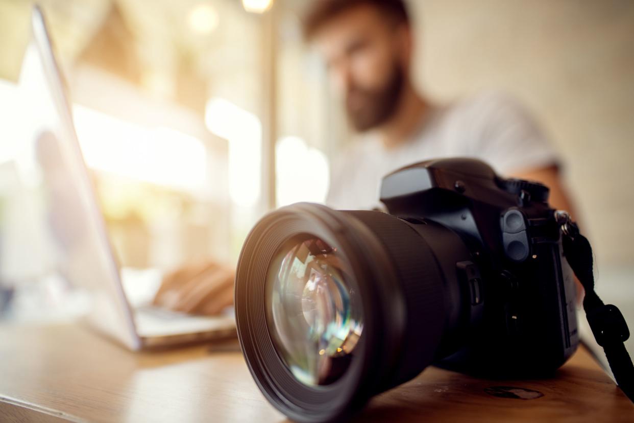 photographer checking his files, off loading on laptop