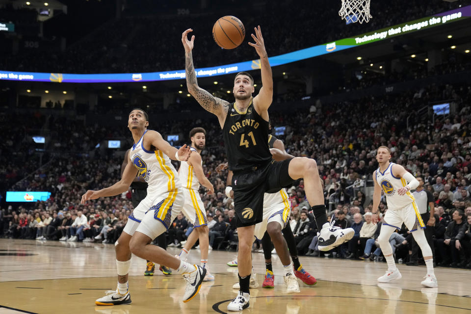 Toronto Raptors forward Juancho Hernangomez (41) looks to receive the ball as Golden State Warriors defenders look on during first-half NBA basketball game action in Toronto, Sunday, Dec. 18, 2022. (Frank Gunn/The Canadian Press via AP)