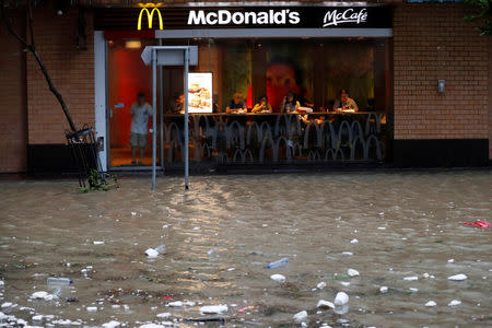 A flooded street is seen outside a McDonalds restaurant as Typhoon Hato hits Hong Kong, China August 23, 2017. REUTERS/Tyrone Siu