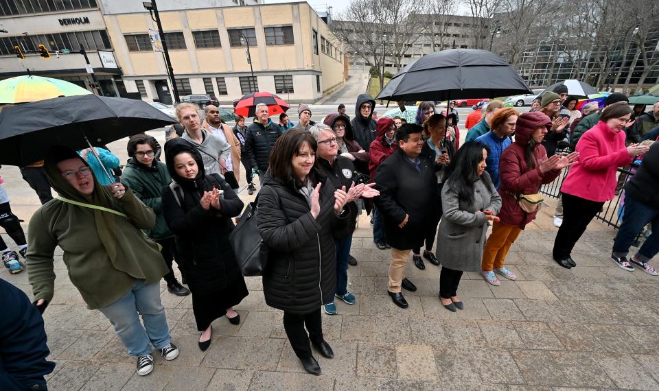 The crowd applauds during the Trans Day of Visibility rally Friday at City Hall. At center are, from left, State Sen. Robyn Kennedy, School Committee member Sue Mailman and Guillermo Creamer Jr., Worcester Human Rights Commission Chair.