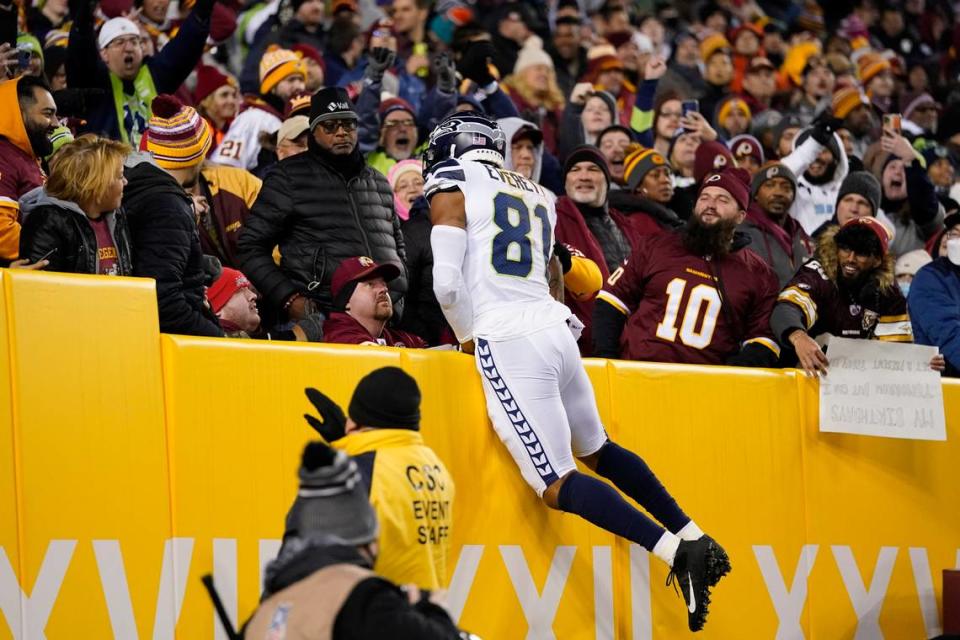 Seattle Seahawks tight end Gerald Everett (81) leaping into the stands after scoring a touchdown against the Washington Football Team during the first half of an NFL football game, Monday, Nov. 29, 2021, in Landover, Md. (AP Photo/Julio Cortez)