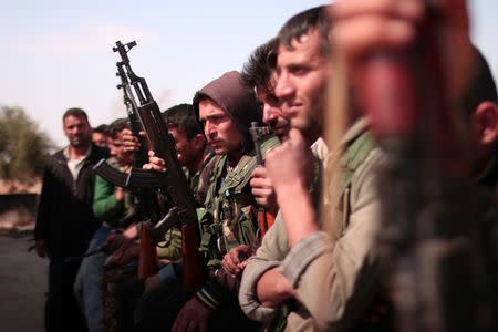 Syrian Democratic Forces(SDF) fighters stand with their weapons north of Raqqa city, Syria March 8, 2017. REUTERS/Rodi Said