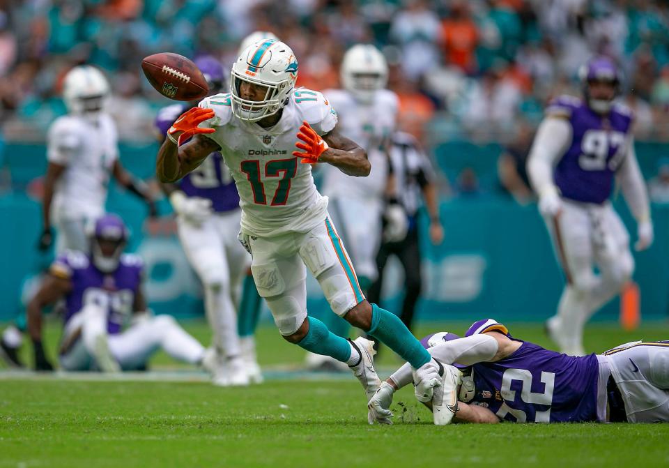 Dolphins receiver Jaylen Waddle fumbles the ball after making a reception late in the fourth quarter of Sunday's loss to the Vikings.