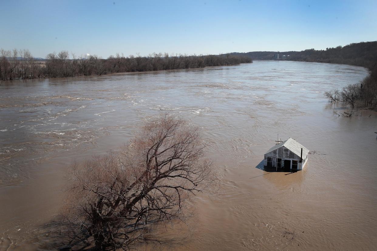 A structure is surrounded by floodwater.