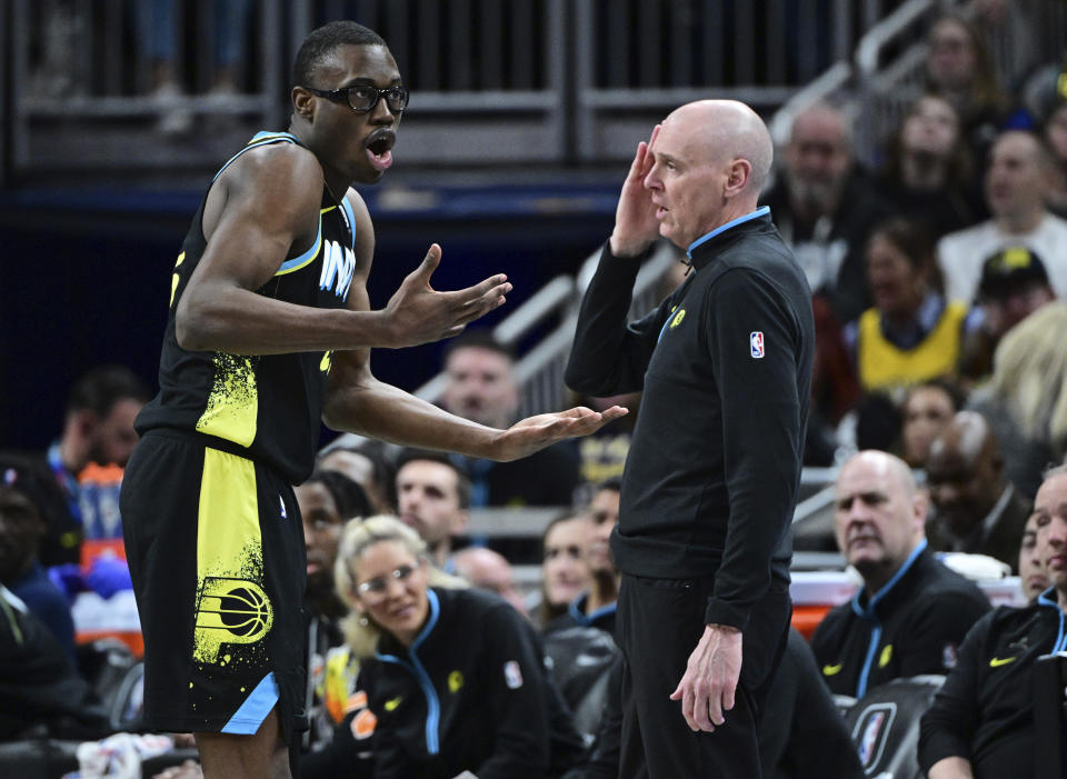 Indiana Pacers forward Jalen Smith talks with coach Rick Carlisle during the first half of the team's NBA basketball game against the New Orleans Pelicans, Wednesday, Feb. 28, 2024, in Indianapolis. (AP Photo/Marc Lebryk)