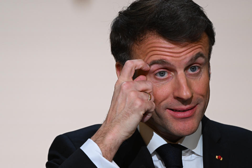 French President Emmanuel Macron scratches his face after delivering a speech ahead of his visit in Central Africa, at the Elysee Palace in Paris, Monday, Feb. 27, 2023. French President Emmanuel Macron unveiled his country's changing economic and military strategy in Africa for the coming years, as France's influence substantially declines on the continent. Macron begins an ambitious Africa trip on Wednesday to Gabon, Angola, the Republic of Congo and Congo.( Stefano Rellandini, Pool via AP)