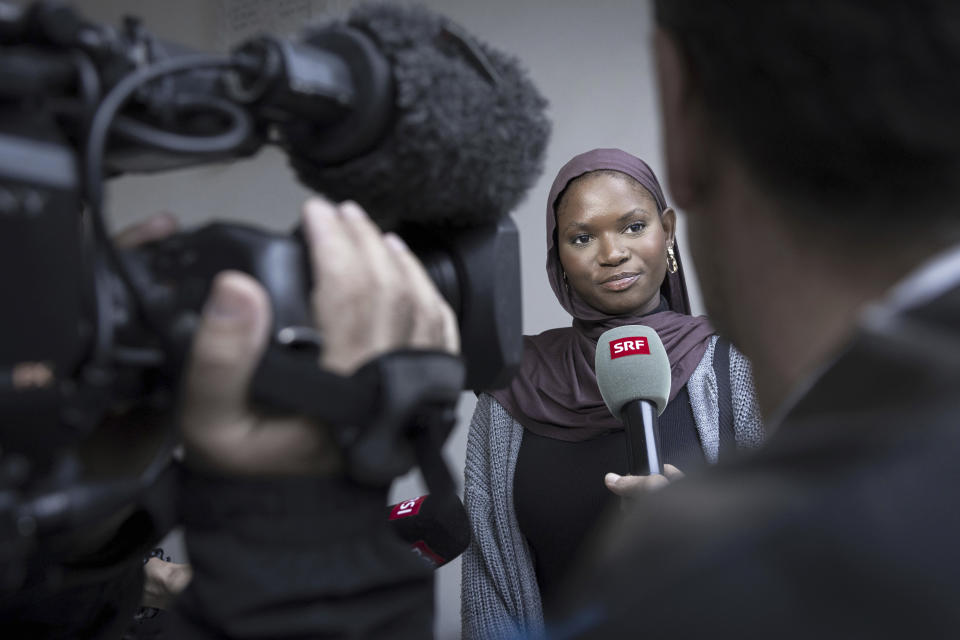 Olimatou Sonko, daughter of Gambia's former Interior Minister Ousman Sonko, talks to the media after the conviction of her father, in front of the Federal Criminal Court of Switzerland in Bellinzona, Wednesday, May 15, 2024. Switzerland’s top criminal court has convicted Ousman Sonko for crimes against humanity over the repression by the west African country’s security forces against opponents of its longtime dictator, a legal advocacy group said Wednesday. (Maria Linda Clericetti/Keystone via AP)