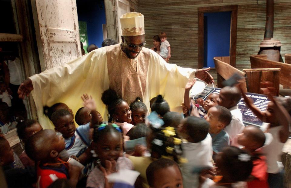 Isaac Hayes greets children from the Zion Day Care and Learning Center at the Hoopers Chapel AME Church on May 2, 3003, inside the Stax Museum of American Soul Music. The Isaac Hayes: Black Moses Gives Back exhibit at the Museum of Science and History showcases his dashikis collection as well as his work in Ghana.