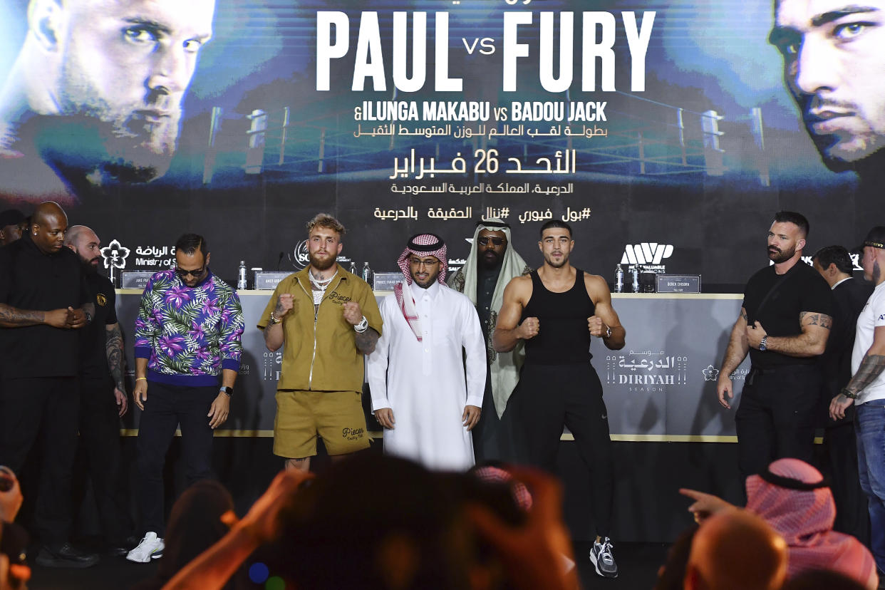 Jake Paul, centre, left, and Tommy Fury, centre right, react after their press conference ahead of their fight, scheduled on Feb. 26, in Riyadh, Saudi Arabia, Thursday, Feb. 23, 2023. (AP Photo)