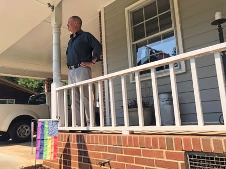 Gerald Bostock, who says he lost his job because he is gay, stands outside his home in Atlanta