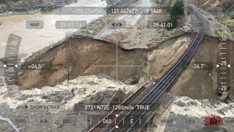 Railway tracks are suspended above the washed out Tank Hill underpass of the Trans Canada Highway 1