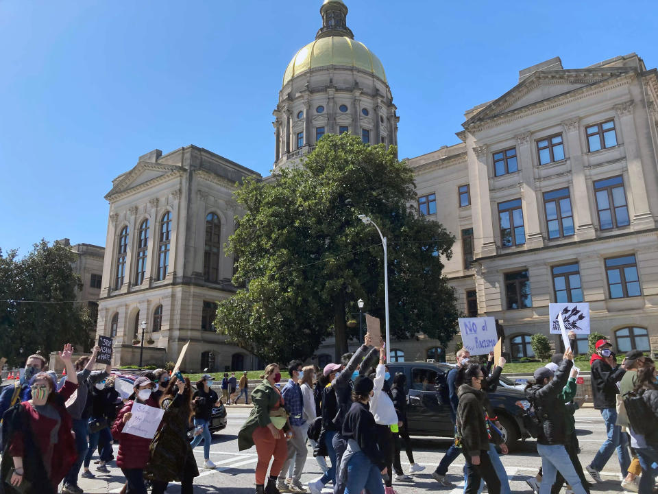 Hundreds of people gather in a park across from the Georgia state Capitol in Atlanta to demand justice for the victims of shootings at massage businesses days earlier, Saturday, March 20, 2021 in Atlanta. (AP Photo/Candice Choi)