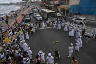 Members of the Indigenous community join Afro Brazilian community members in a protest march, in Salvador, Brazil, Sunday, Sept. 18, 2022. Protesters called on authorities to take action against projects that would have environmental impact on the dunes, including one to accommodate evangelical pilgrims congregating at the Abaete dune system, an area members of the Afro Brazilian faiths consider sacred. (AP Photo/Rodrigo Abd)