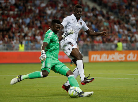 Soccer Football - Champions League - OGC Nice vs Ajax Amsterdam - Third Qualifying Round First Leg - Nice, France - July 26, 2017 Ajax's Andre Onana in action with Nice's Mario Balotelli REUTERS/Eric Gaillard