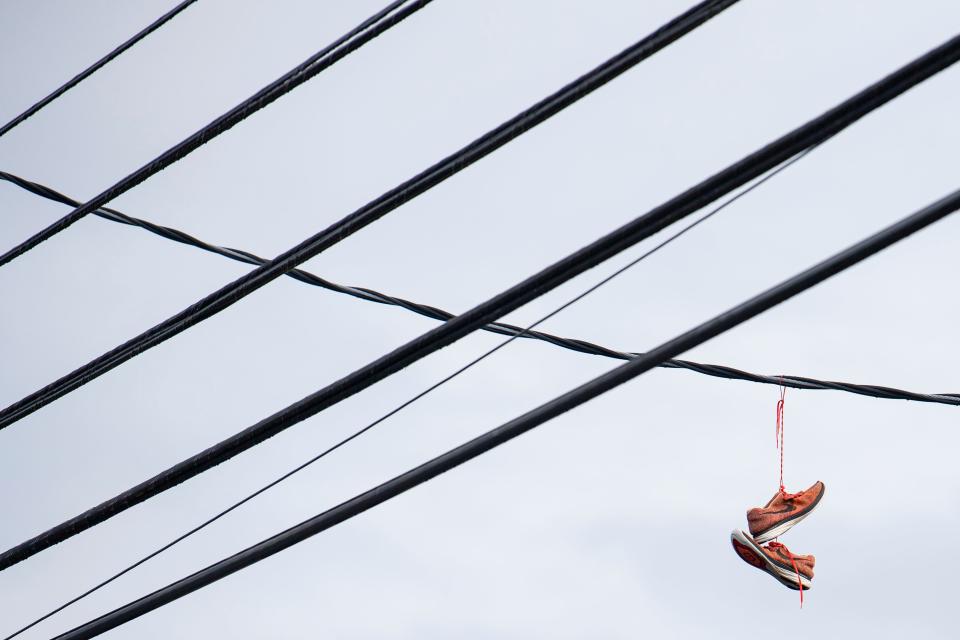 A pair of shoes dangle from utility lines in the 300 block of Lancaster Drive NE on Feb. 19.