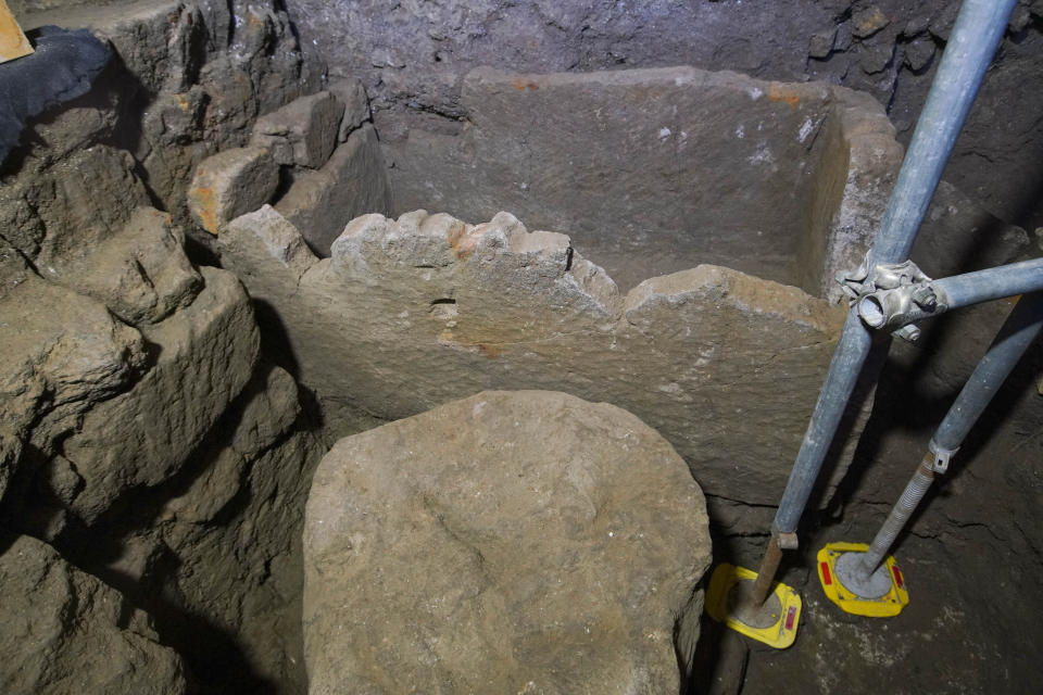 A 1.4-meter (55-inch) wide sarcophagus and what appears to be an altar, dating back to the 6th Century B.C., are seen in an underground chamber, at the ancient Roman Forum, during an unveiling to media, in Rome, Friday, Feb. 21, 2020. Archaeologists believe the underground shrine, who's finding was announced earlier this week, was dedicated to Romulus, the founder of the ancient city. (AP Photo/Andrew Medichini)