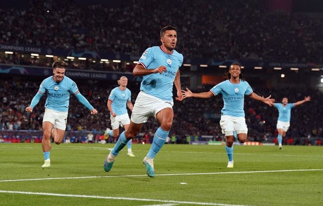 Rodri pursued by his team-mates after scoring the only goal of a tense Champions League final
