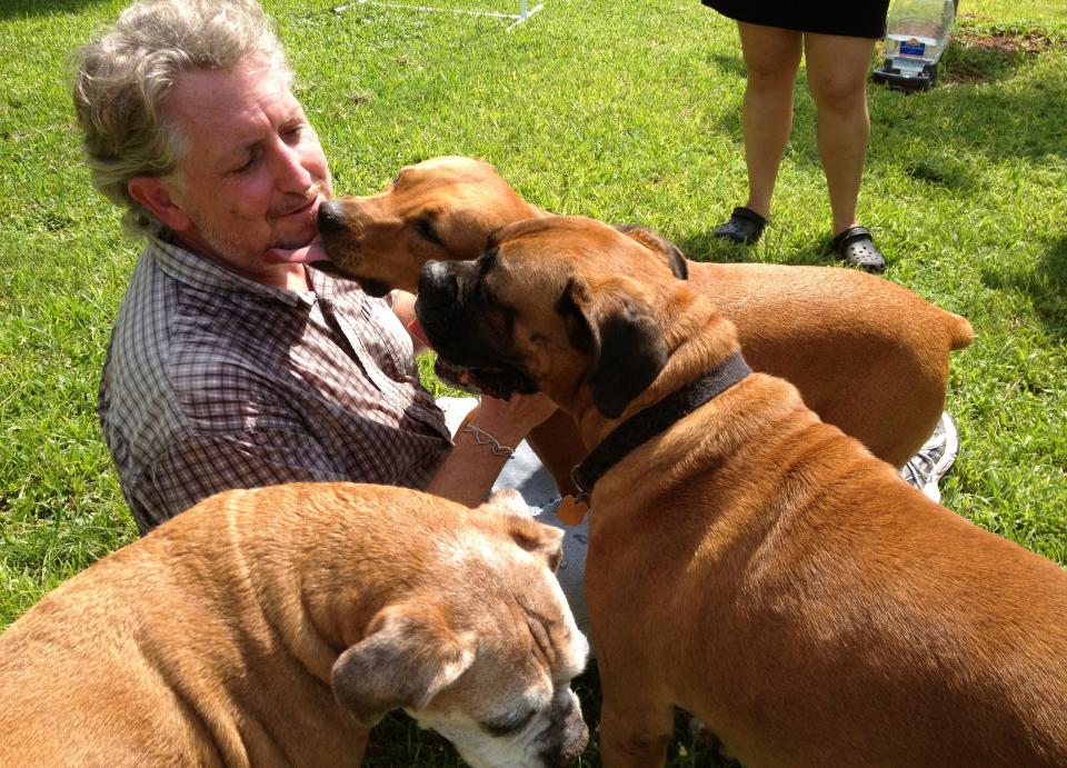 Eric Staats gets a kiss by Pippa as his dogs Winnie and Cooper (bottom left to right) look on at the  Malibu Lakes apartment complex in 2013. Not pictured is his dog Murphy. (Photo by Vonna Keomanyvong)