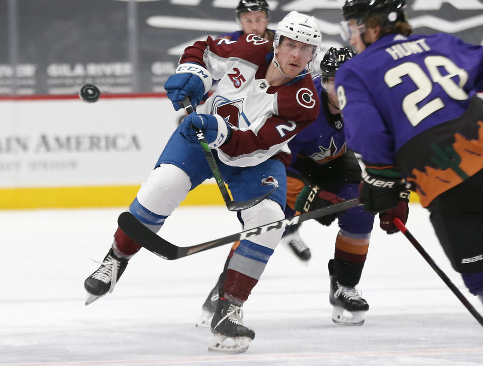 Colorado Avalanche's Logan O'Connor (25) passes the puck up ice against Arizona Coyotes' Dryden Hunt (28) during the third period of an NHL hockey game Saturday, Feb. 27, 2021, in Glendale, Ariz. (AP Photo/Darryl Webb)