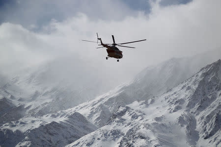 Emergency and rescue helicopter searches for the plane that crashed in a mountainous area of central Iran, February 19, 2018. REUTERS/Tasnim News Agency