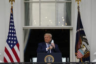 President Donald Trump removes his face mask to speak from the Blue Room Balcony of the White House to a crowd of supporters, Saturday, Oct. 10, 2020, in Washington. (AP Photo/Alex Brandon)