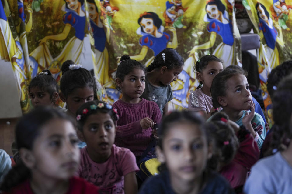 Children attend an activity at a makeshift class in Deir al Balah, on Sunday, April 21, 2024. Since the war erupted Oct 7, all schools in Gaza have closed, and nearly 90% of school buildings are damaged or destroyed, according to aid groups. (AP Photo/Abdel Kareen Hana)