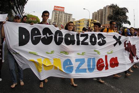 Anti-government protesters march barefooted during a protest in Caracas April 16, 2014. REUTERS/Christian Veron