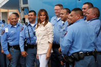 <p>First lady Melania Trump poses with local police officers at the McAllen airport as she prepares to depart after a visit to the U.S.-Mexico border area in McAllen Texas, June 21, 2018. (Photo: Kevin Lamarque/Reuters) </p>