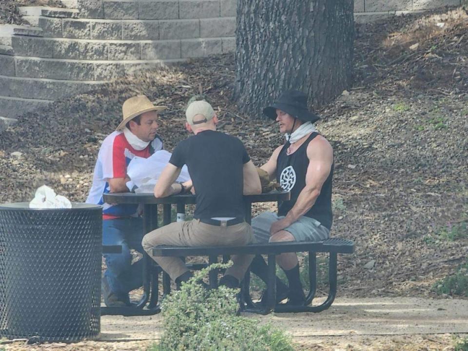 Three men believed to be a part of a group holding a “white pride” banner in May 2023 pictured after their demonstration in Templeton.