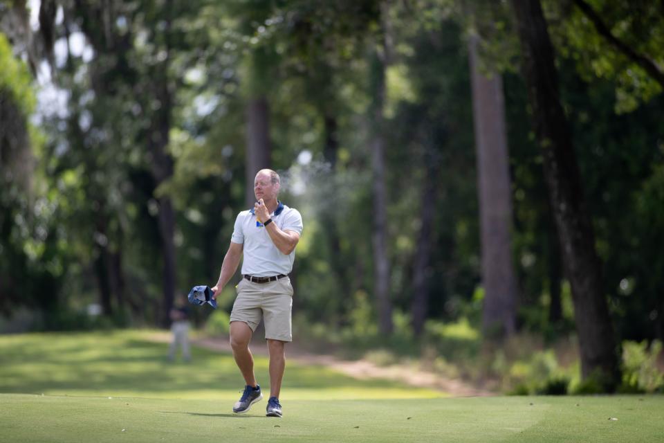 A coach applies sunscreen during the NCAA Tallahassee Regional at Seminole Legacy Golf Club in Tallahassee Tuesday, May 18, 2021.