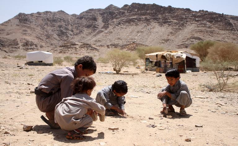 Yemeni children, who fled with their family from Sirwah due to the fighting between Huthi rebels and militiamen loyal to Yemen's fugitive President Hadi, play outside their shelter on April 24, 2015, on the outskirts of the Yemen's Mareb province