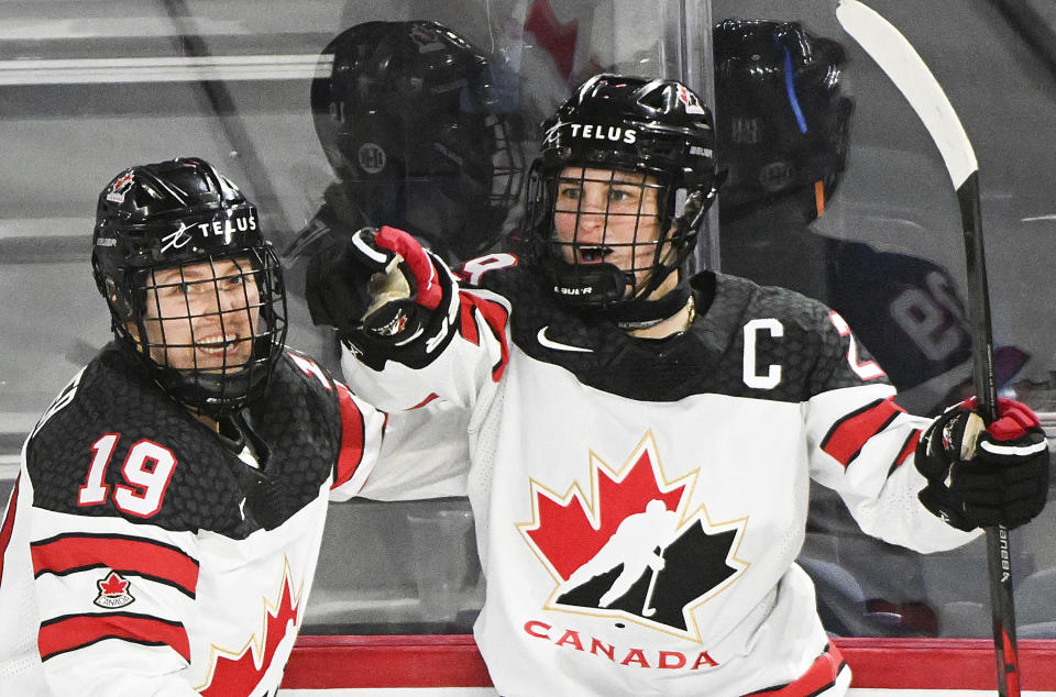 FILE - Canada's Marie-Philip Poulin, right, celebrates with Brianne Jenner after scoring against the Unite States during the second period of Rivalry Series hockey game Wednesday, Feb. 22, 2023, in Laval, Quebec. The Canadians enter the world championships as two-time defending champions. (Graham Hughes/The Canadian Press via AP, File)