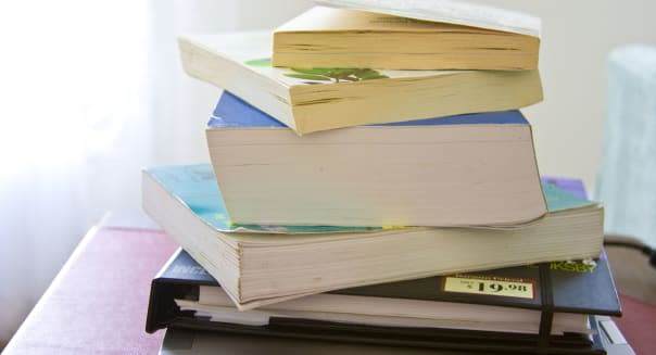 College textbooks books stack  stack of student reading material