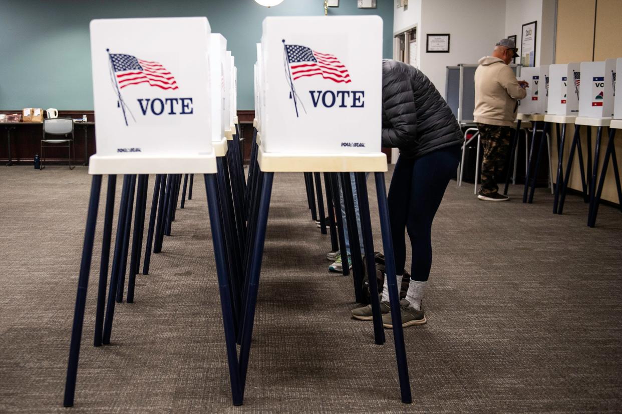 Voters fill out ballots inside the Lory Student Center drop-off location in Fort Collins, Colo., on Tuesday, Nov. 7, 2023.