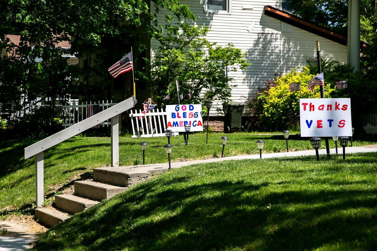 Signs in a yard read, "God bless America" and "Thanks Vets" on Memorial Day, Monday, May 29, 2023, in Iowa City, Iowa.