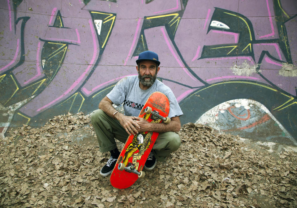 Skateboarder Dallas Oberholzer, 46, poses for a photo at the Germiston Lake Skateboard Park, near Johannesburg, Saturday, July 3, 2021. The age-range of competitors in skateboarding's Olympic debut at the Tokyo Games is remarkably broad and 46-year-old Dallas Oberholzer will go wheel-to-wheel with skaters less than half his age. (AP Photo/Denis Farrell)