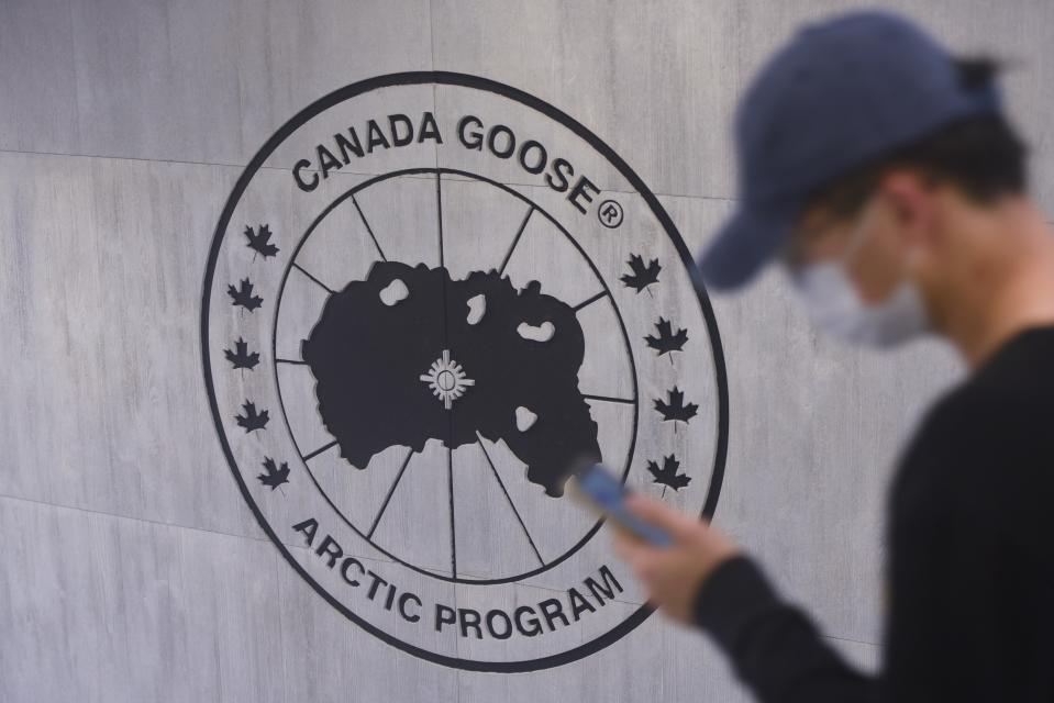 HANGZHOU, CHINA - DECEMBER 01 2021: A man walks by a store of Canada Goose in Hangzhou in east Chinas Zhejiang province Wednesday, Dec. 01, 2021. The Canadian brand has announced its Chinese shops will offer refunding to customers for returned goods, after a fineprint of the otherwise was disclosed by a customer and went viral on the Chinese Internet. (Photo credit should read LONG WEI/Future Publishing via Getty Images)