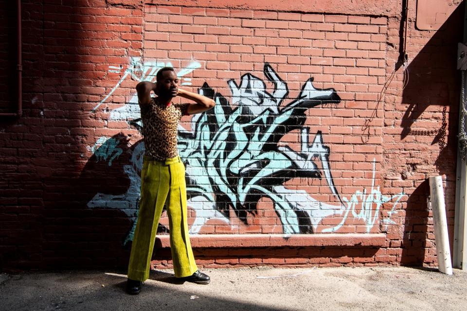 Kenneth Nicholson wears a look from his own label in an alley outside his studio in downtown Los Angeles.